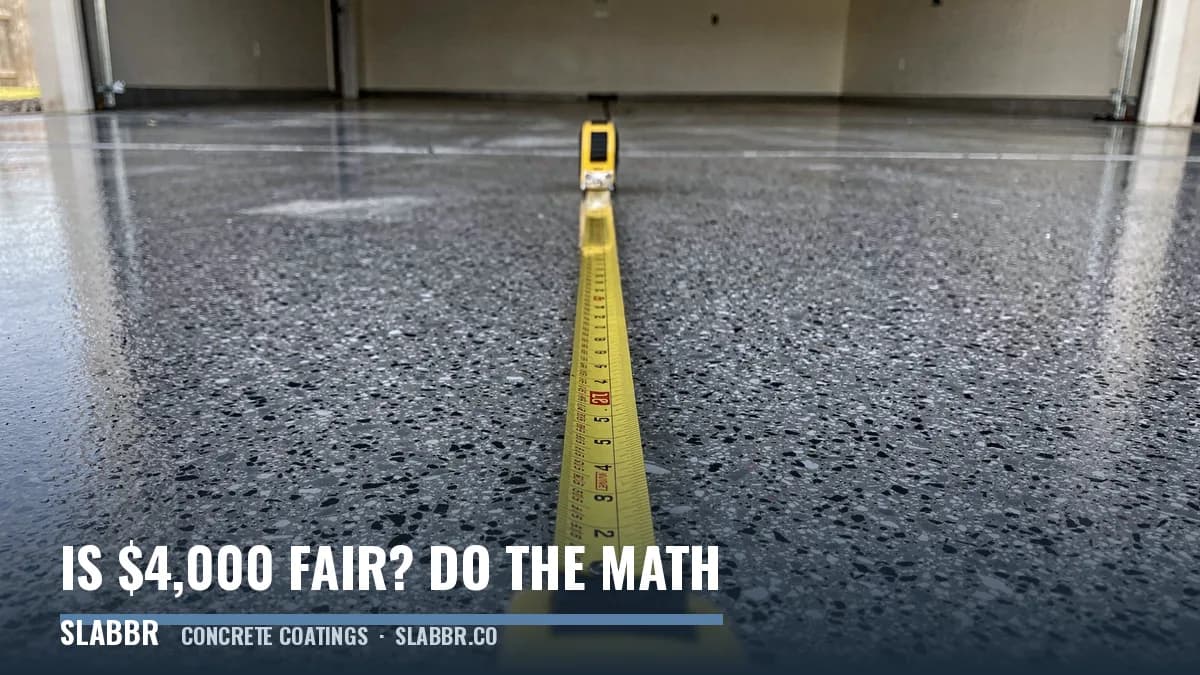 A steel tape measure extended across a finished gray and black flake coated two-car garage floor